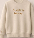 Sweatshirt „Stabilität ist sexy.“ in Beige mit goldbraunem Print